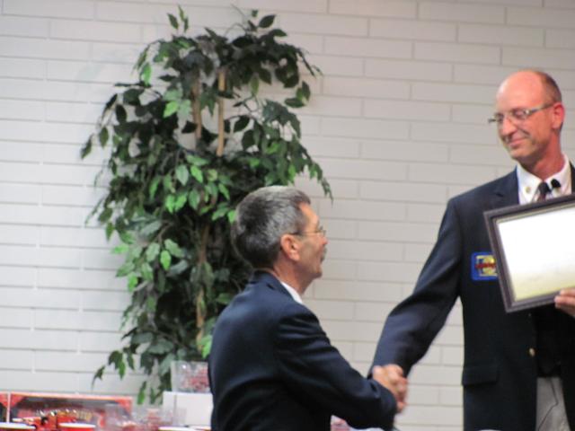 Wayne Schipper receiving certificate of appreciation, from President Arnold, for his 25 years of service to the IFCA at the 2010 Fall Conference.